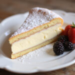 Slice of Gâteau Au Fromage Blanc with berries, a delicious French dessert ready to enjoy.