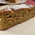 Finished Gâteau Aux Noix with a sprinkle of powdered sugar, ideal for serving at home.