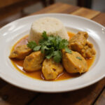 Delicious Poulet Curry Coco served with rice, perfect for a cozy meal.