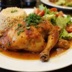 Finished Poulet Basquaise served with rice and salad, ideal for a delightful meal.