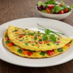 Beautifully plated vegetable omelette, colorful and healthy, ideal for a quick meal.