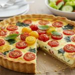 Quiche estivale aux tomates cerises et épinards, délicieusement présentée pour un repas d'été.