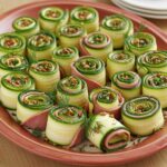 Beautifully presented roulés de courgettes au jambon as a fresh apéritif.