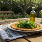 Deliciously plated socca niçoise with fresh arugula, an ideal summer dish to enjoy outdoors.