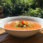 Finished bowl of cold gaspacho de tomate, perfect for enjoying during summer picnics.