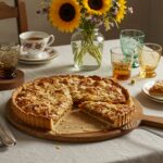 Finished tarte aux abricots elegantly presented with almond garnish.