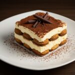 Finished tiramisu léger dessert with creamy layers and cocoa, an elegant Italian treat.