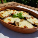 Finished aubergines au four with melted mozzarella, a delightful dish to enjoy.