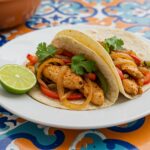 Delicious chicken fajitas ready to be served, featuring vibrant colors and garnishes for a delightful meal.