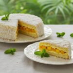 Slice of gâteau Colibri served on a plate, showcasing its tropical flavors and moist texture.