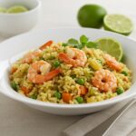 Finished riz frit avec crevettes served with lime wedges, perfect for a delicious Asian meal.