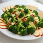 Finished salade de brocoli with apples and walnuts, a fresh and healthy dish for any meal.